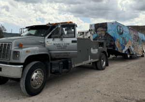 RV being towed through West Texas desert landscape toward Alpine after mechanical issues.